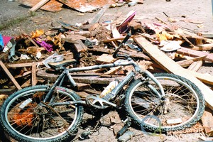 Bicycle in flood debris collected at Street Facility after the Spring Creek Flood