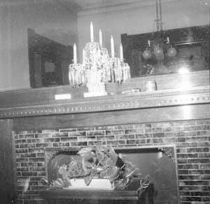 Mantel of fireplace on west wall
