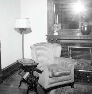 Chair by fireplace in northwest corner