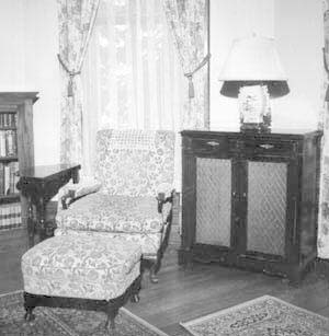 Northeast corner with chair, ottoman,and radio