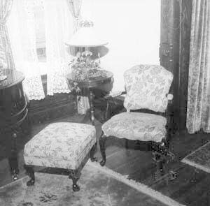 Chair, ottoman & table in northeast corner
