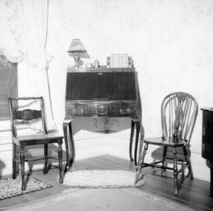 Desk and two chairs in southwest corner