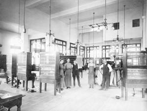 Employees at Fort Collins Post Office on College Avenue (l. to r.: Edith Peggy Bair, Fanny Tenney Dowdell (stamps), Frank Slayton, Roy Inmann and Marshall Moore (Post Master), c. 1912-1914